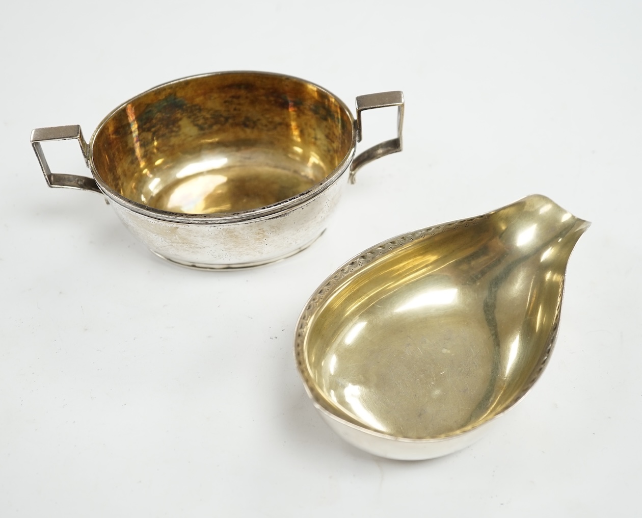 A George III silver two handled oval tub salt by John Eames, London, 1806, 12cm, together with a Georgian silver pap boat (marks rubbed). Condition - poor to fair